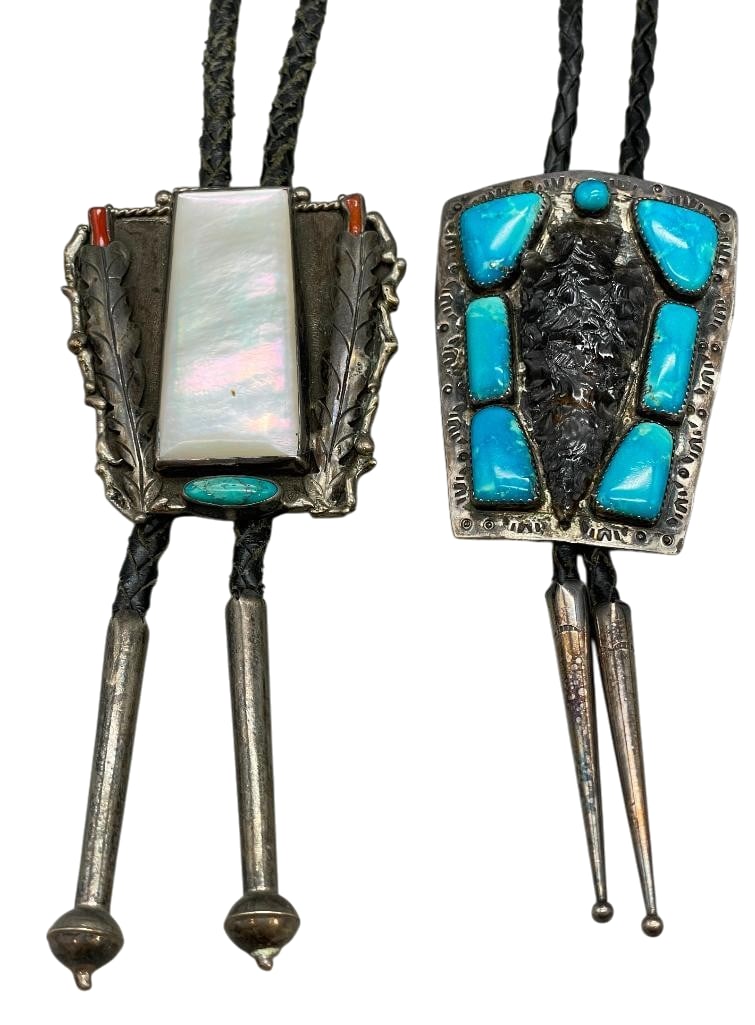 Two Nice Vintage Bolo Ties: Offered here for your consideration are two nice vintage bolo ties. The slide on the first bolo features an obsidian arrowhead and seven turquoise cabochons set in silver accented with hand stamped de
