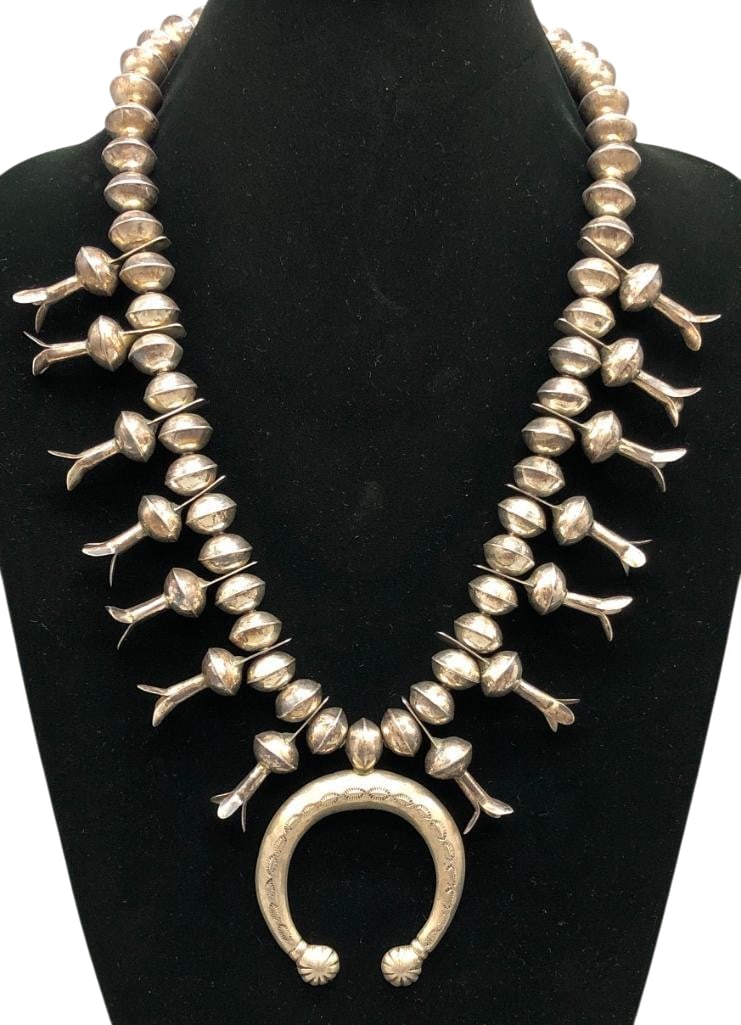 Vintage Sterling Silver Squash Blossom Necklace: Offered here for your consideration is a vintage sterling silver squash blossom necklace. This piece features a cast naja accented with hand stamped designs. The neckline is filled with with 14 silver