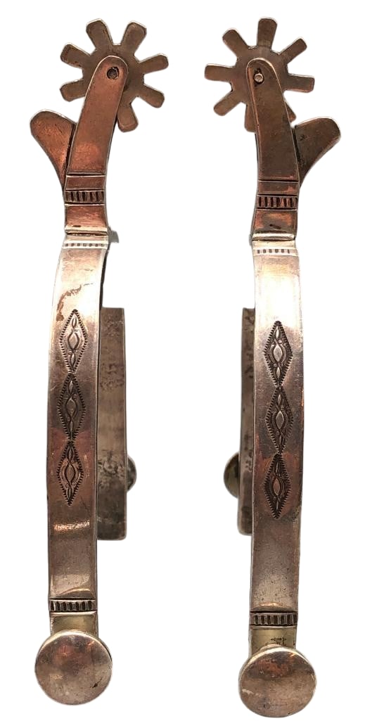 Navajo Sterling Silver Hallmarked AT Spurs: Available here for your consideration is a pair of Navajo sterling silver spurs hallmarked AT. These spurs feature engraved silver designs along the heel bands and shanks on both sides. They have eigh