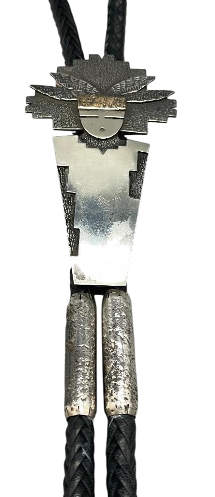 Statement Sterling Silver Bolo Tie By Peter Royball: Offered in this lot is a statement sterling silver bolo tie by Peter Royball. This slide features a striking Kachina design created with cast work. The design is accented by a darkened, textured backg