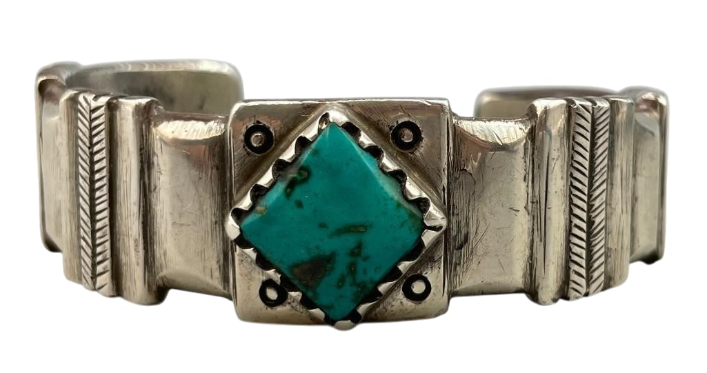 Coin Silver And Turquoise Bracelet By Jock Favour: For your bidding enjoyment we present a coin silver and turquoise bracelet by Jock Favour. This bracelet features a diamond shaped turquoise cabochon set in a sawtooth silver bezel. The stone is on a 