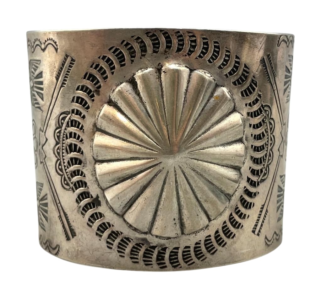 Wide Fred Harvey Era Sterling Silver Bracelet: For your bidding enjoyment we present a wide Fred Harvey era sterling silver bracelet. This bracelet features a silver cuff accented with a repousse center surrounded by hand stamped patterns. Bid now