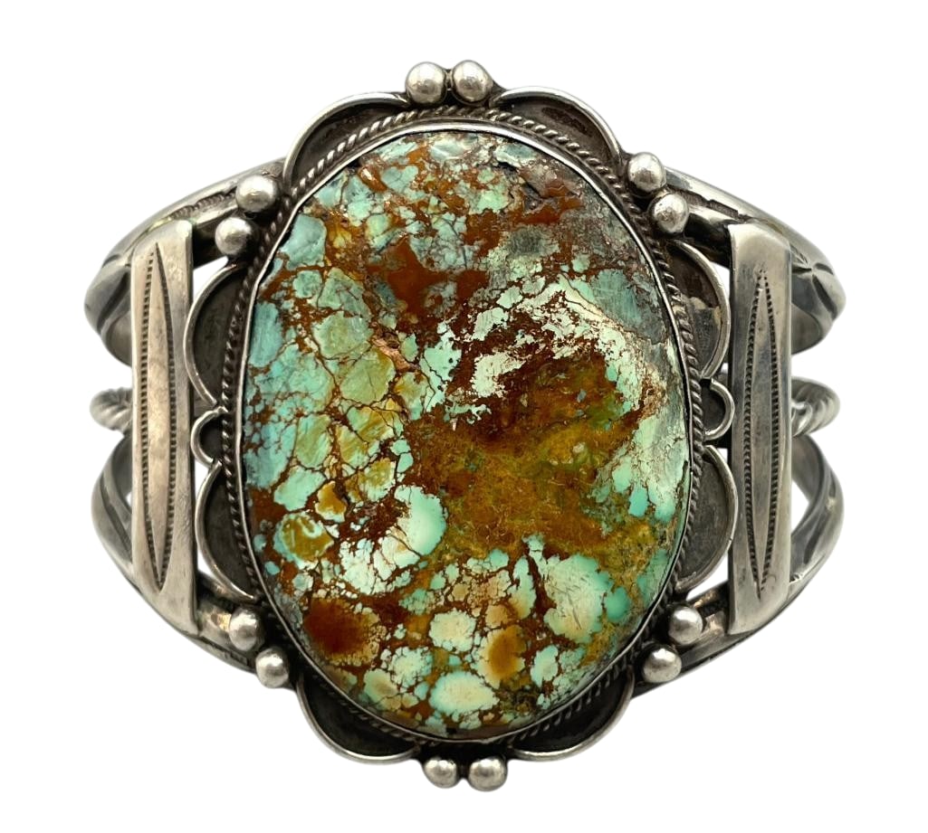 Vintage Nice Turquoise And Sterling Silver Bracelet: For your bidding enjoyment we present a vintage nice turquoise and sterling silver bracelet. This bracelet features a turquoise cabochon with brown webbing set in a smooth silver bezel. Surrounding th