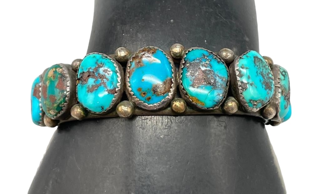 Eight Stone Turquoise And Sterling Silver Bracelet: Offered here for your consideration is an eight stone turquoise and sterling silver bracelet. This piece features eight turquoise cabochons set in sawtooth silver bezels accented with silver dots. Com