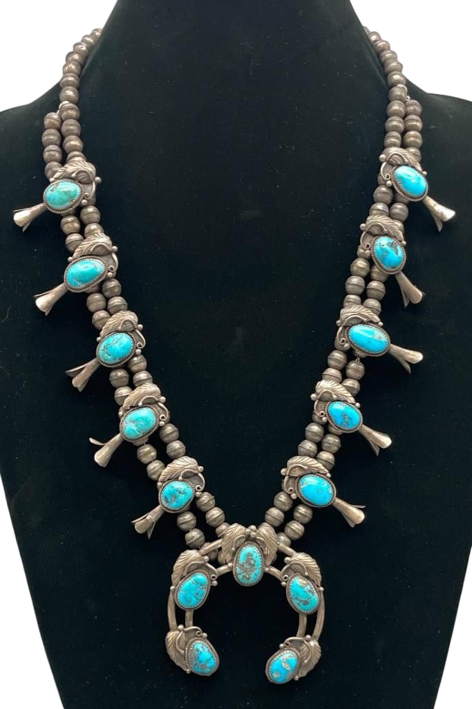 Vintage Sterling Silver And Turquoise Squash Blossom Necklace: Offered here for your consideration is a vintage sterling silver and turquoise squash blossom necklace. The two wire naja features five turquoise cabochons set in sawtooth silver bezels. Accenting the