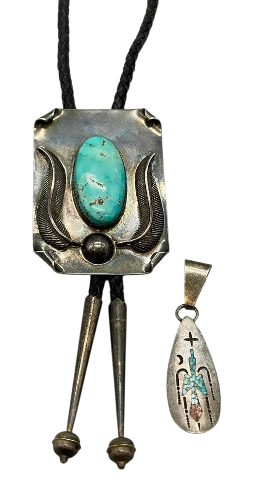 Sterling Silver And Turquoise Bolo Tie With Singer Inlay Pendant: Offered in this lot is a sterling silver and turquoise bolo tie with Singer inlay pendant. The slide features a turquoise cabochon set in sawtooth silver bezel. Accenting the stone is a silver dot, le