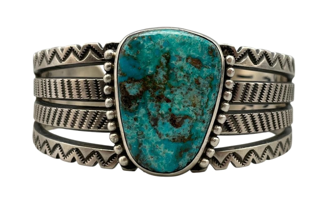 Sterling Silver And Battle Mountain Turquoise Bracelet By V. Jackson: For your bidding enjoyment we present a sterling silver and Battle Mountain turquoise bracelet by V. Jackson. This bracelet features a turquoise cabochon set in a smooth silver bezel. On the sides of 