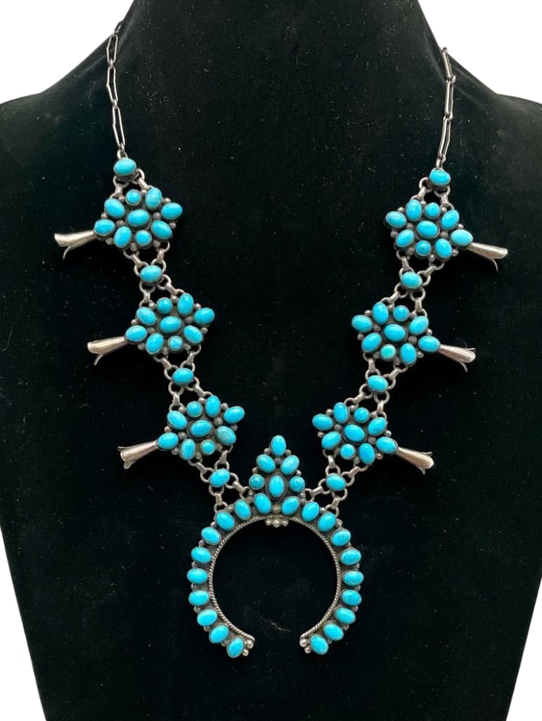 Sterling Silver And Turquoise Necklace - Squash Blossom Style In Design: Offered here for your consideration is a sterling silver and turquoise necklace - squash blossom style in design. This necklace features a naja highlighted with several turquoise cabochons set in smoo