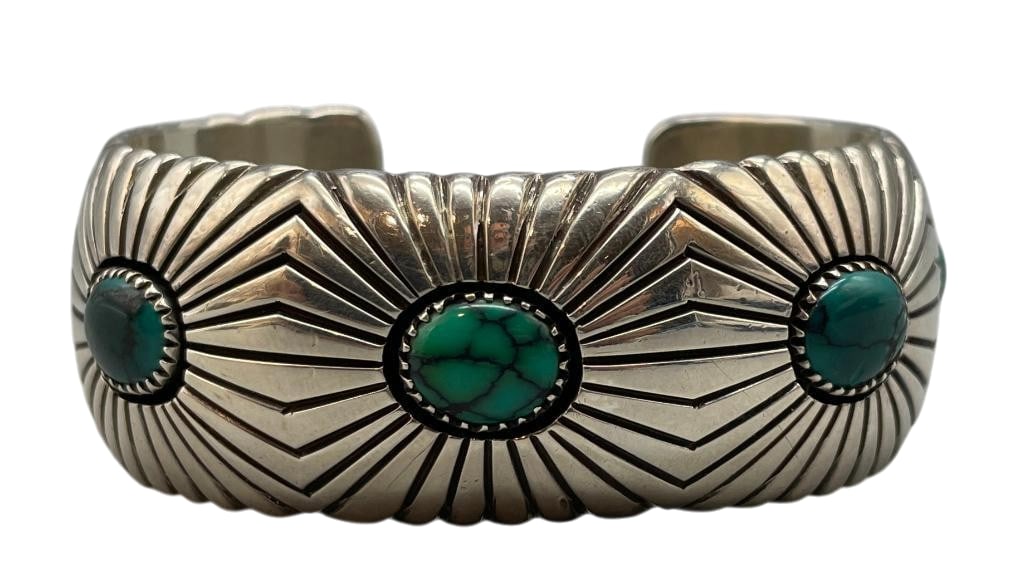 Sterling Silver And Nice Turquoise Bracelet By Phillip Begay: For your bidding enjoyment we present a sterling silver and nice turquoise bracelet by Phillip Begay. This bracelet features five turquoise cabochons set in sawtooth silver bezels. Surrounding the sto