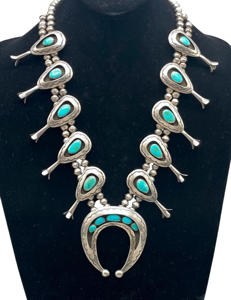 Sterling Silver And Turquoise Shadow Box Style Squash Blossom Necklace Marked GJ: Offered here for your consideration is a sterling silver and turquoise shadow box style squash blossom necklace marked GJ. The naja features five turquoise cabochons set in smooth silver bezels accent
