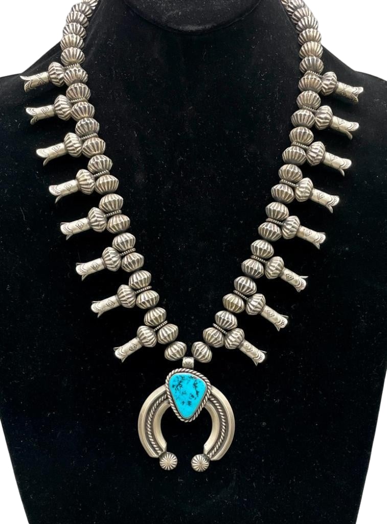 Sterling Silver Fluted Bead, Stamped Blossom and Turquoise Necklace by Eugene Hale: Offered here for your consideration is a sterling silver fluted bead, stamped blossom and turquoise necklace by Eugene Hale. This necklace features a three wire naja highlighted with a central twisted