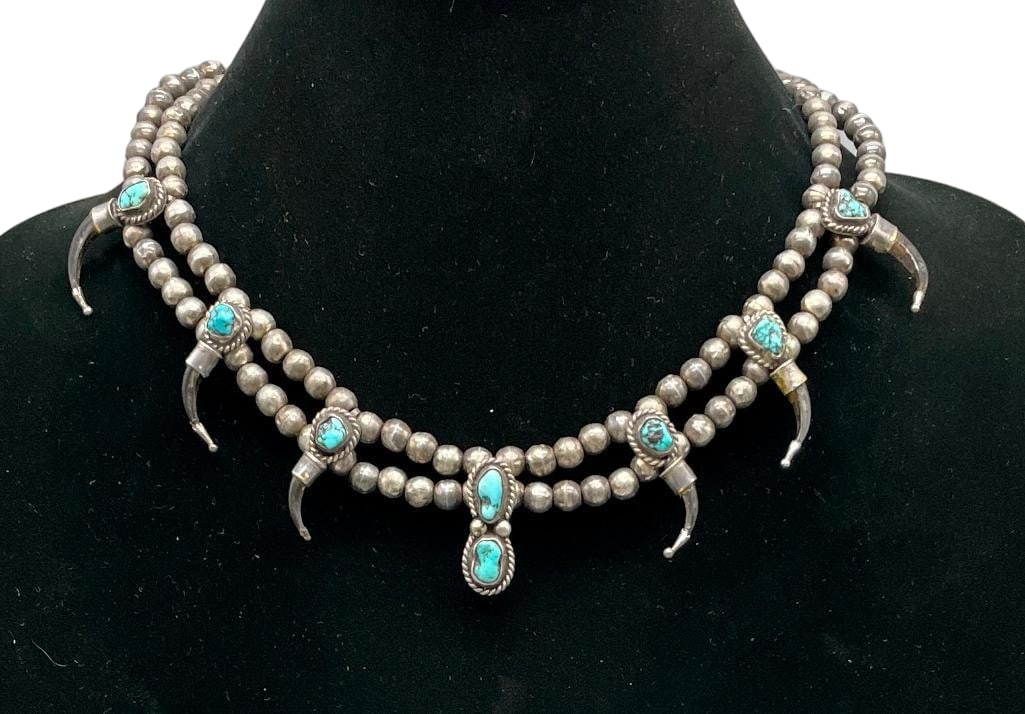 Sterling Silver And Faux Claw Theme Beaded Necklace with Turquoise: Offered here for your consideration is a sterling silver and faux claw theme beaded necklace with turquoise. This piece features seven pendants highlighted with turquoise cabochons set in smooth silve