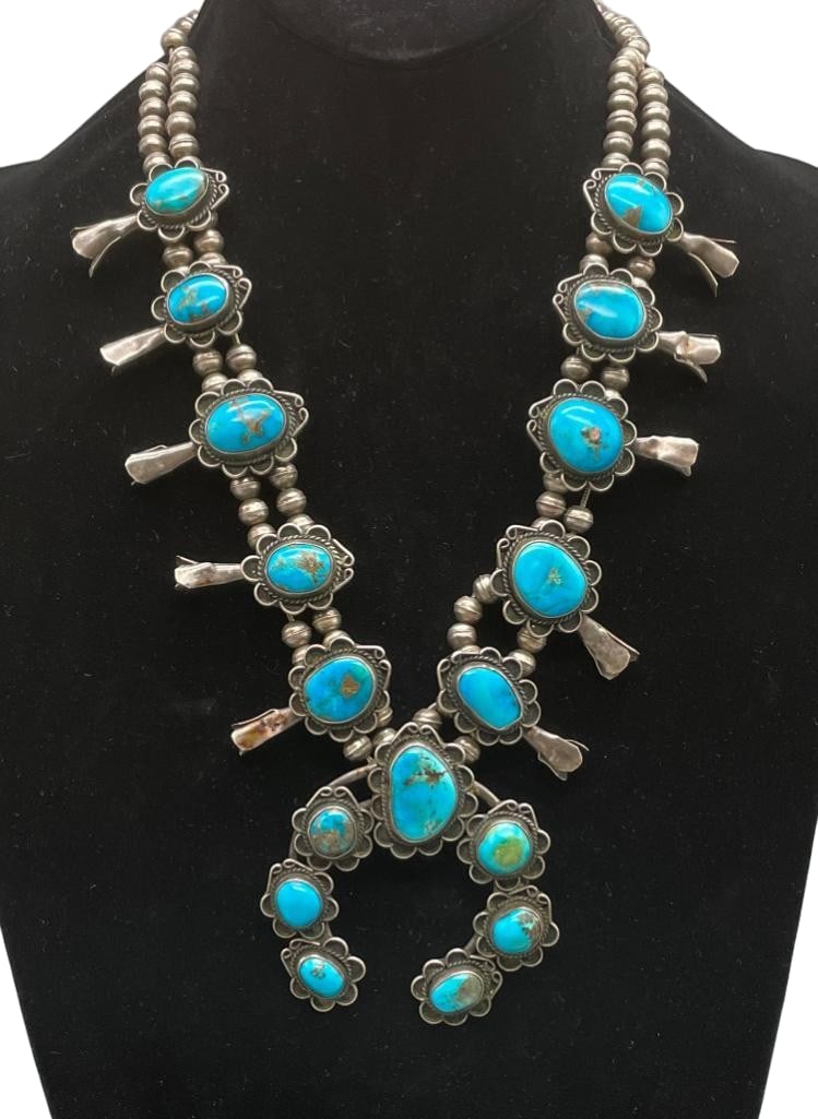 Vintage Sterling Silver And Blue Turquoise Squash Blossom Necklace: Offered here for your consideration is a vintage sterling silver and blue turquoise squash blossom necklace. This necklace features a two wire naja highlighted with seven turquoise cabochons all set i