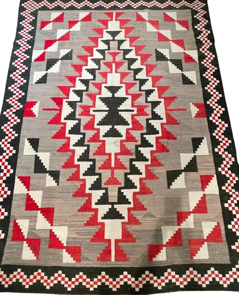Large Klagetoh Navajo Rug Circa 1950s: Available here for your consideration is a large Klagetoh Navajo rug from circa the 1950s. This one is hand carded and hand spun, featuring a central geometric pattern in black white and red surrounde