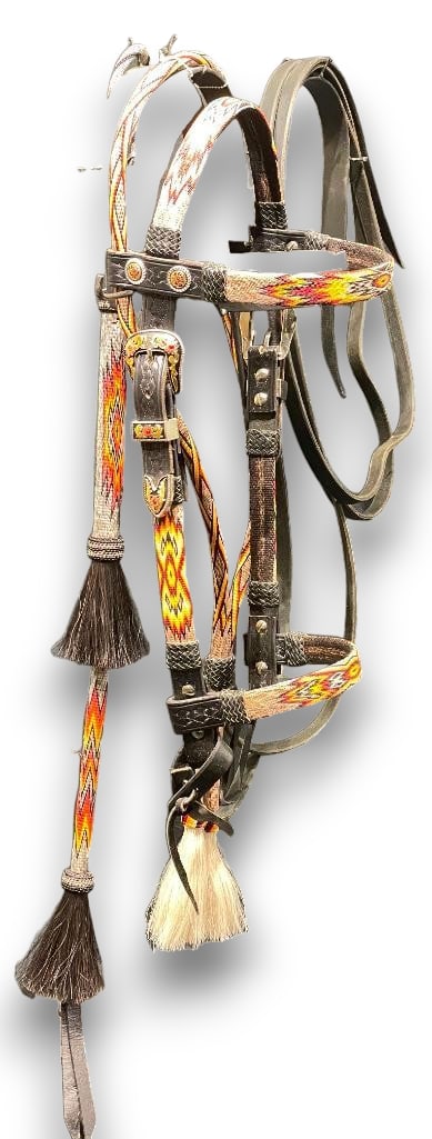 Hitched Horsehair Headstall and Quirt: Offered here for your consideration is a hitched horsehair headstall and quirt. Both feature hand hitched horsehair in red, yellow, white and black geometric patterns with tassels. The headstall has t