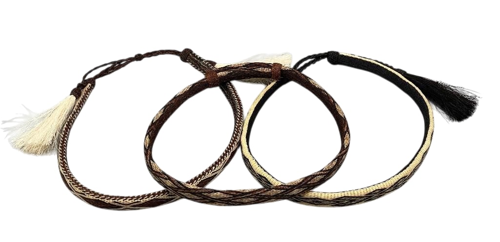 Group of Three Deer Lodge Hitched Horsehair Hatbands: Offered here for your consideration is a group of three Deer Lodge hitched horsehair hatbands. They feature hitched horsehair designs in shades of black, cream and brown finished with horsehair tassel