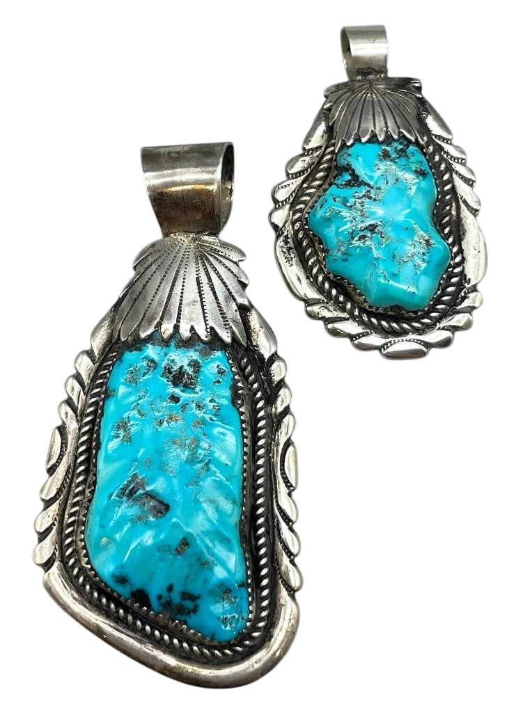 Two Turquoise and Sterling Silver Pendants by Robert and Bernice Leekya: Offered here for your consideration are two turquoise and sterling silver pendants by Robert and Bernice Leekya. The pendants feature carved turquoise cabochons set in sawtooth silver bezels. Accentin