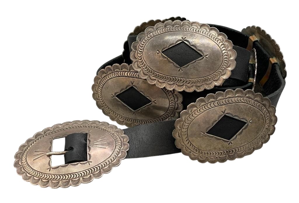 Vintage Sterling Silver Stamped Concho Belt: Offered here for your consideration is a vintage sterling silver concho belt. The belt has eight oval conchos and a matching buckle. Each highlighted with a central cutout, hand stamped patterns and s