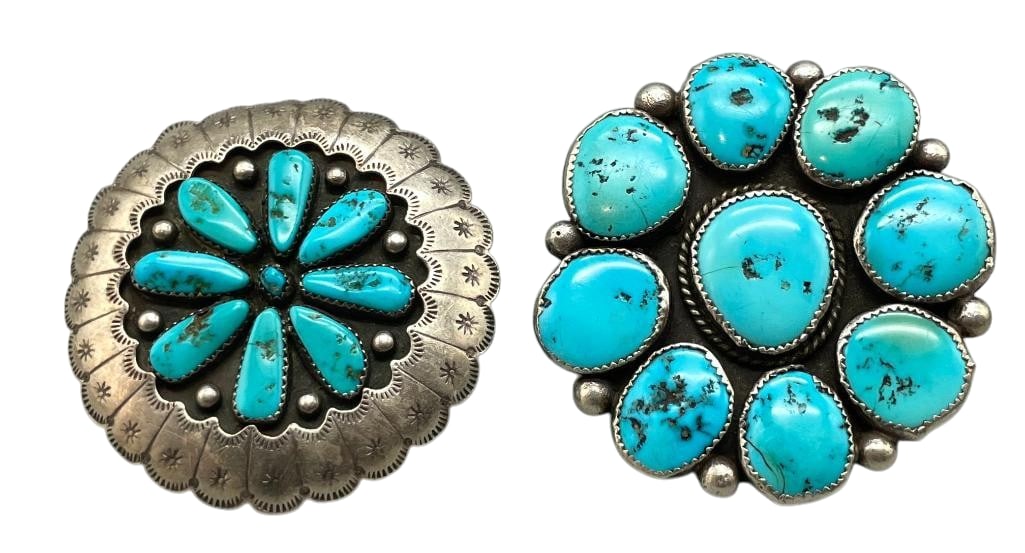 Two Statement Sterling Silver And Turquoise Rings: Offered here are two statement sterling silver rings, each featuring a cluster of turquoise cabochons set within handmade sawtooth bezels. Both rings are accented with darkened backgrounds and silver 