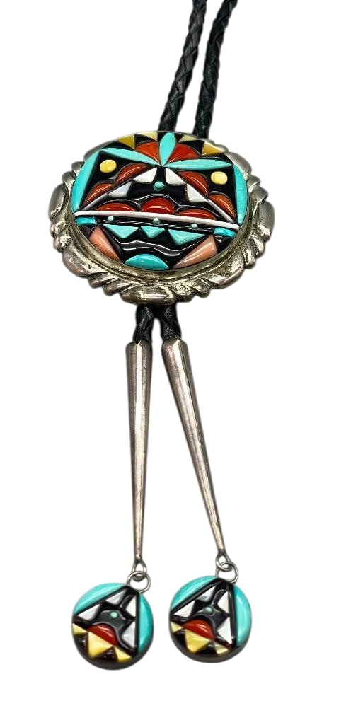 Zuni Multi Stone Bolo By Virginia And Wayne Quam: Offered in this lot is a Zuni multi stone bolo by Virginia Quam. The sterling silver slide features a great inlay design created with turquoise, onyx, mother of pearl, coral and more. The motif is set