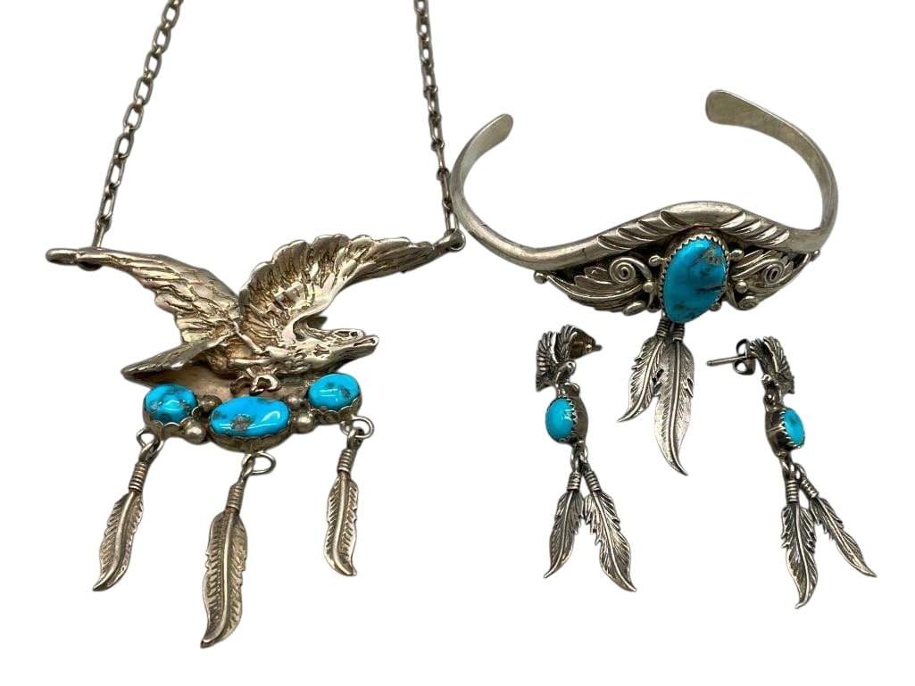 Eagle Theme Necklace With Earrings And Bracelet Circa 1980s-1990s: Offered here is a eagle theme necklace with earrings and bracelet that are circa 1980s-1990s. The pieces each feature turquoise cabochons set in sawtooth silver bezels accented with feather dangles, s