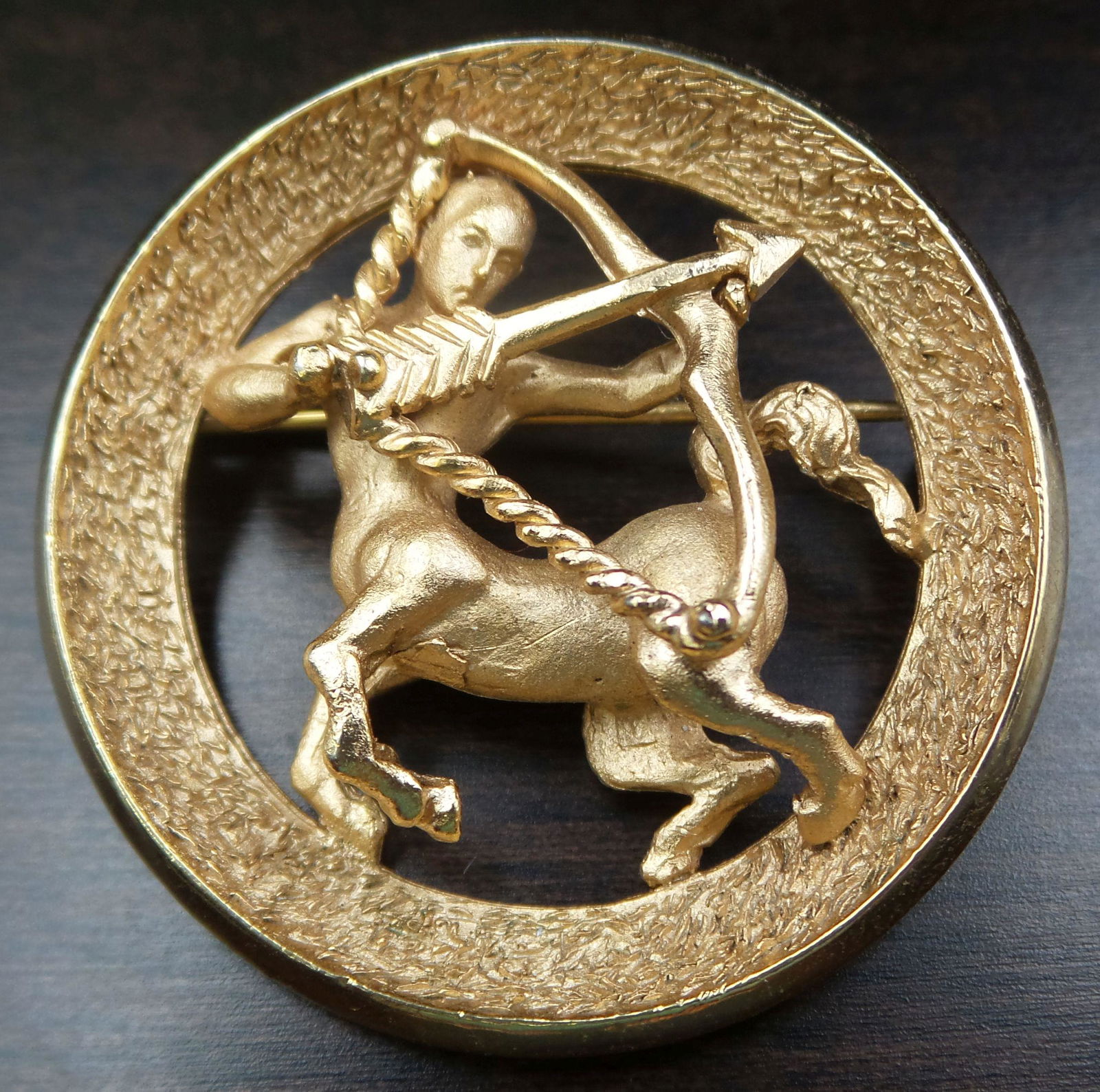 Vintage TRIFARI Gilt Metal Saggitarius Zodiac Costume Jewelry Brooch: Measures approx. 1 3/8" in diameter and weighs ca. 14.5 grams. Stamped "TRIFARI".