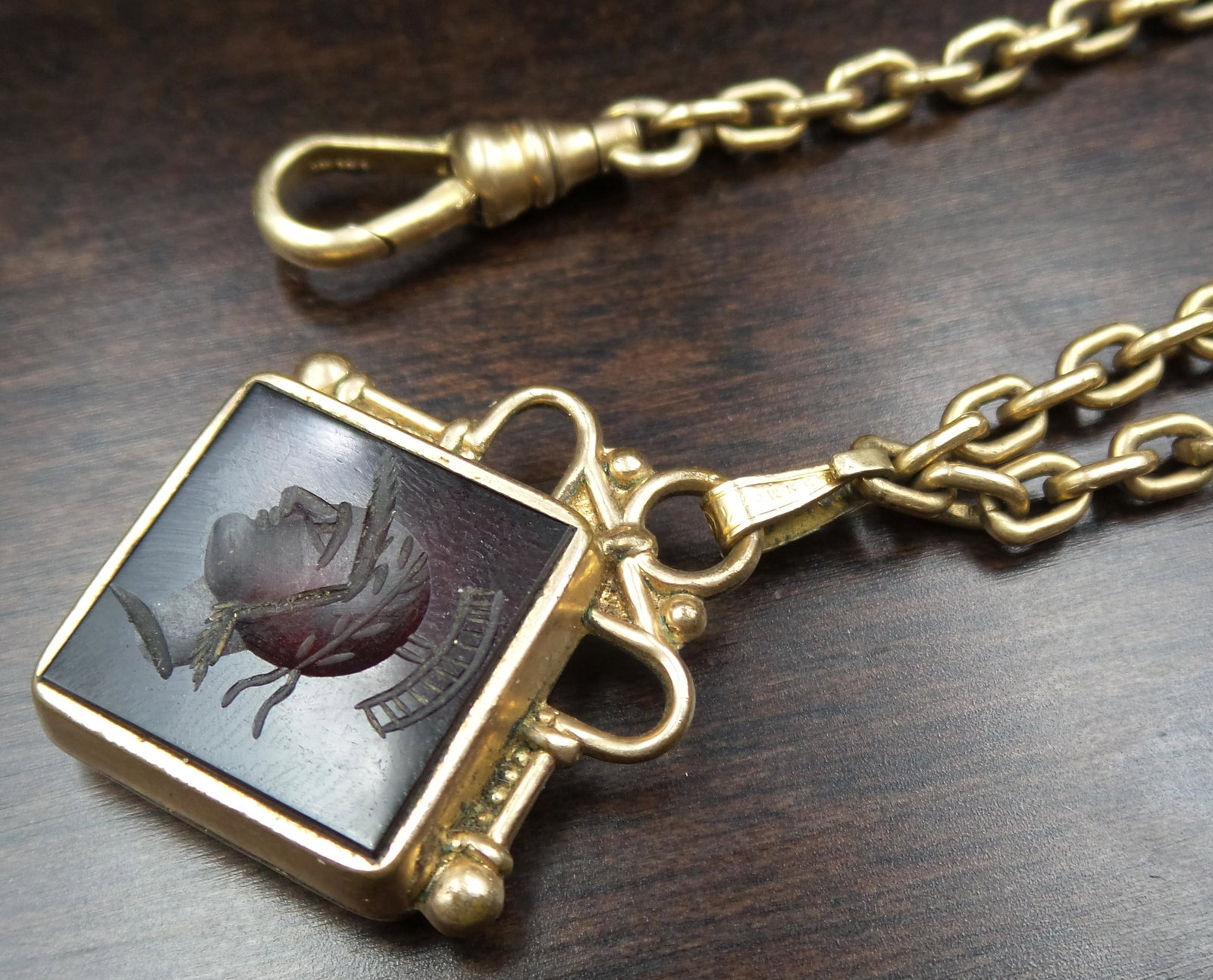 Antique ca. 1900 Gold Filled Pocket Watch Chain /w Gemstone Intaglio Fob: Beautiful piece, ca. 1900. Measures approx. 12" long, weighs ca. 18.6 grams, and features a T-Bar, a lobster clasp, and a gemstone intaglio fob - likely carved from a garnet. Very good antique conditi