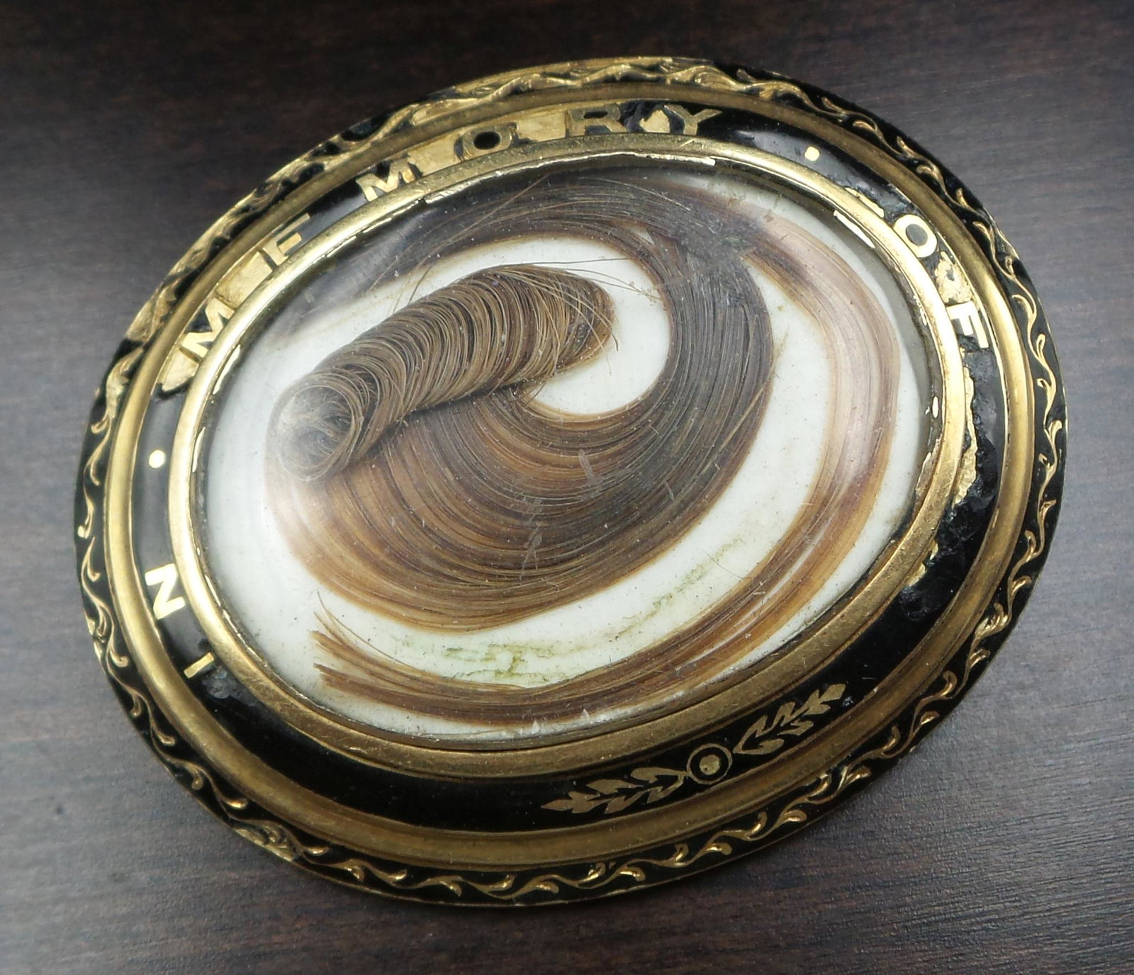 Large Antique Victorian 14K Gold, Black Enamel & French Hair Art Mourning Jewelry Brooch: A large antique mourning/sentimental locket front brooch. Crafted in solid 14K gold. The brooch features a glass compartment and ornate gold repousse work against a jet black enamel background which i