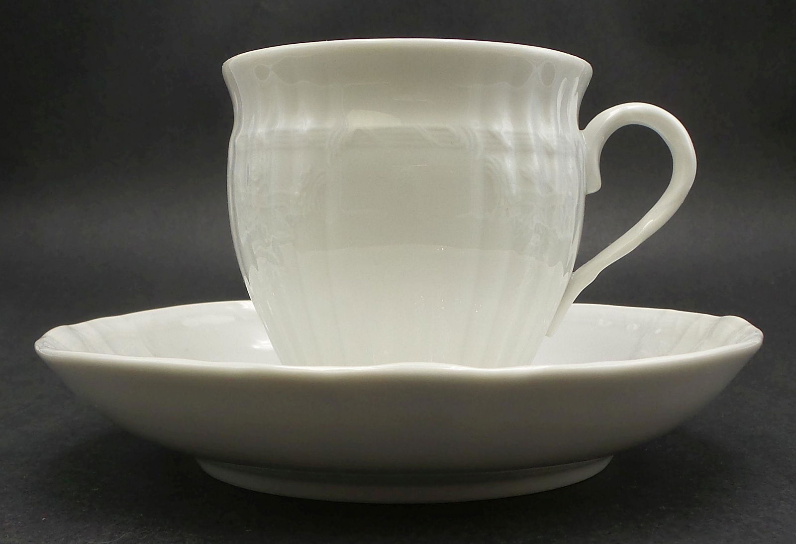 Antique KPM Germany White Porcelain Cup & Saucer: Saucer measures approx. 5 3/8" in diameter, the cup measures approx. 2 7/8" in diameter x 2 5/8" high. Very good antique condition with no chips, cracks, or repairs. Marked with the blue KPM "scepter"