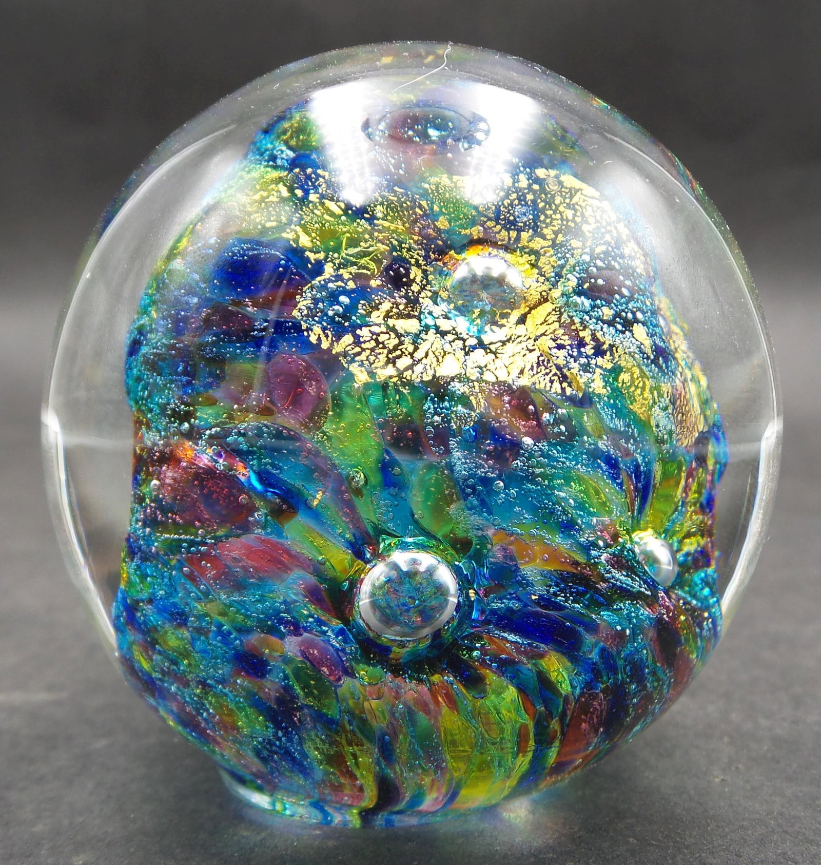 Vintage Goldflake Art Glass Studio Paperweight: Beautiful piece with twirls of blue and red, air bubbles, and gold flakes. Measures approx. 2 1/8" in diameter. Very good vintage condition with no damage.