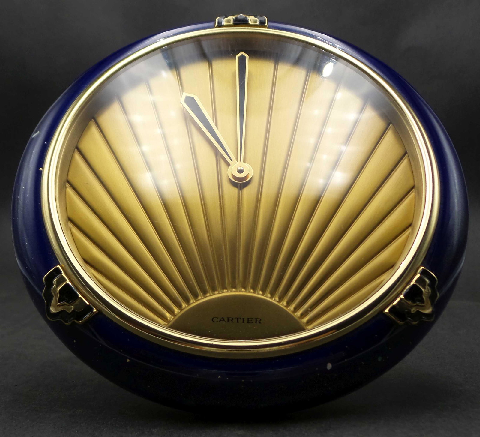 Vintage Art Deco Style CARTIER Brass & Blue Enamel Table Clock: Very beautiful piece featuring an Art Deco style surise dial and set in a blue ceramic frame imitating Lapis Lazuli. Very good vintage condition, has a new battery and works nicely. Missing the pin us