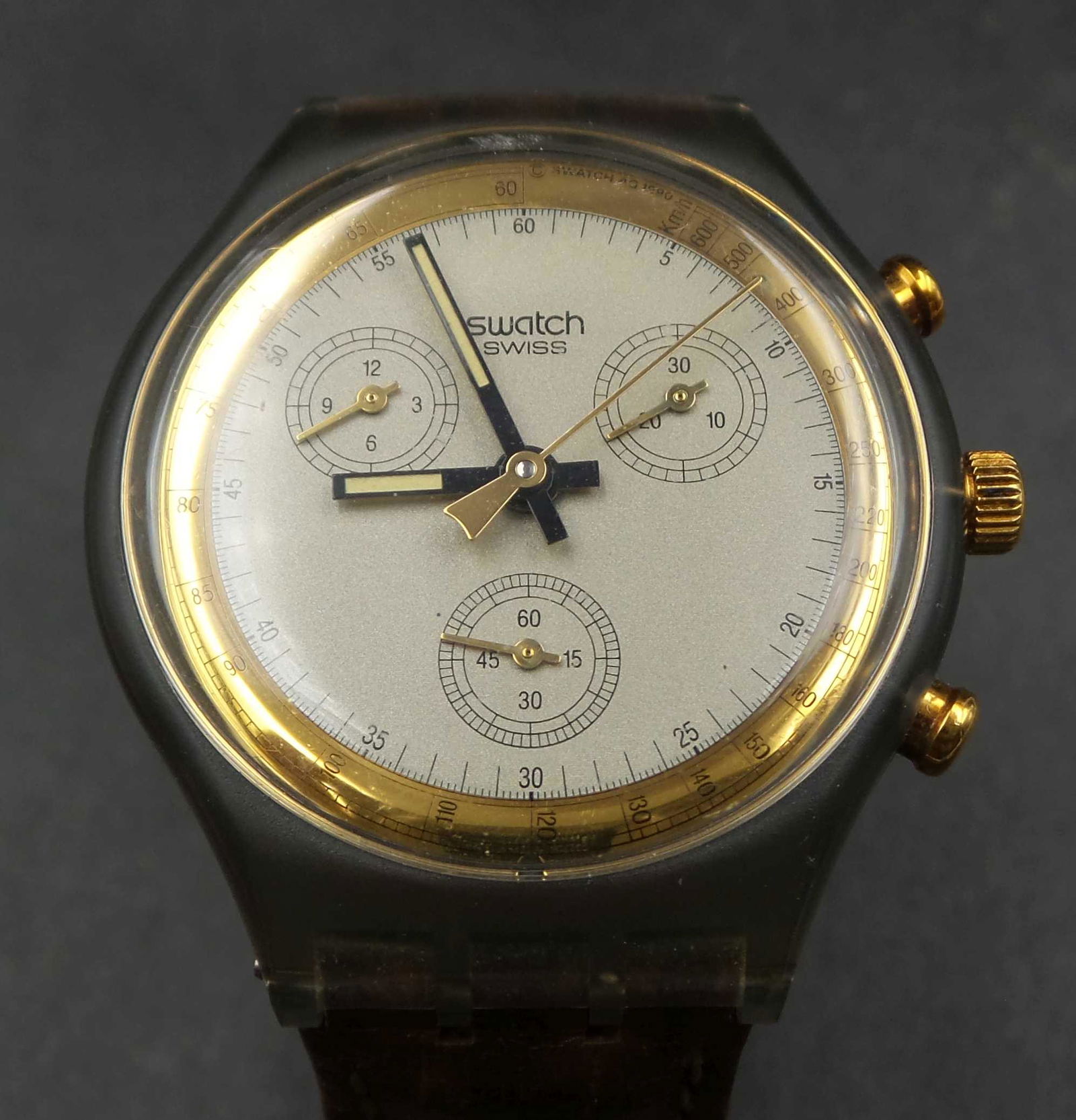 Vintage 1991 SWATCH SCM100 "Goldfinger" Chronograph Watch: This Swatch watch was released in the Spring-Summer of 1991. The Chrono (graph) line of watches were first released by Swatch in 1990 and discontinued in 1998, they were replaced by the â€œChrono