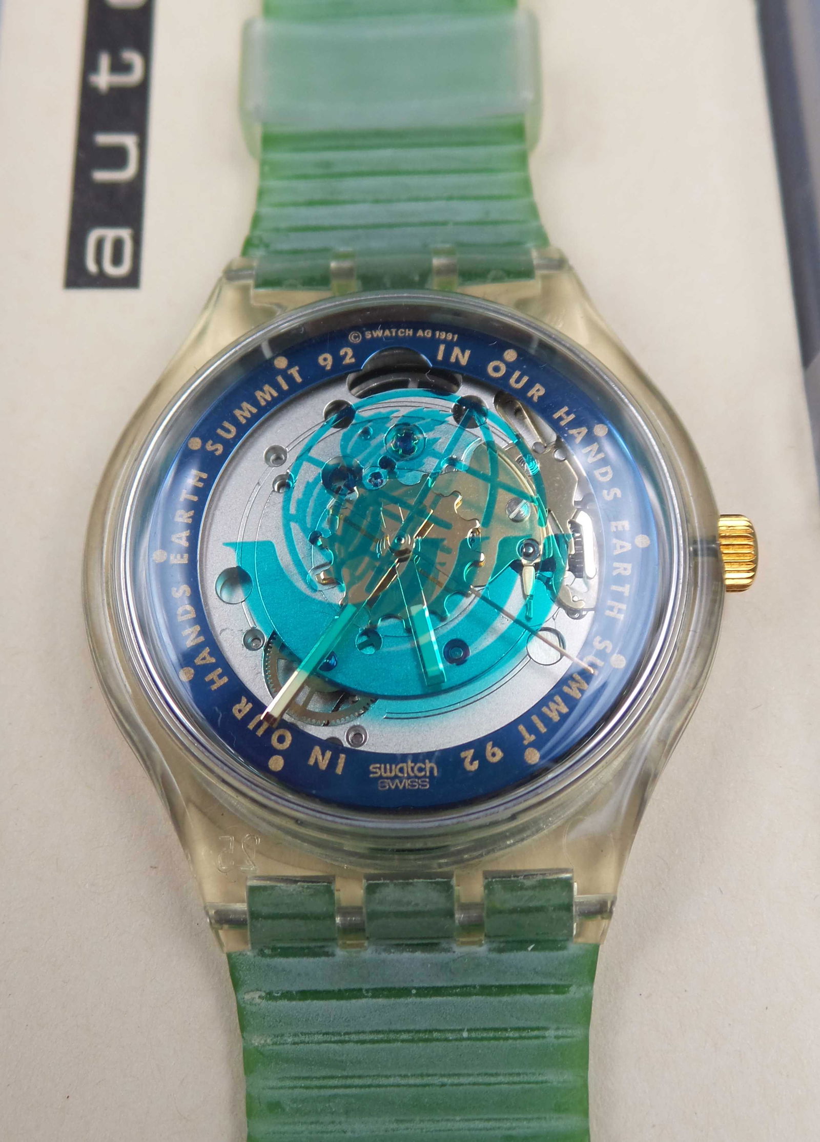 Vintage 1992 SWATCH SAK102 "Time to Move" Automatic Watch: See-through back of dial to the movement of the watch, 36mm wide case, and 17mm wide green plastic strap. Glow-in-the-dark hands.The watch commemorates the 1992 United Nations' Earth Summit in Rio de