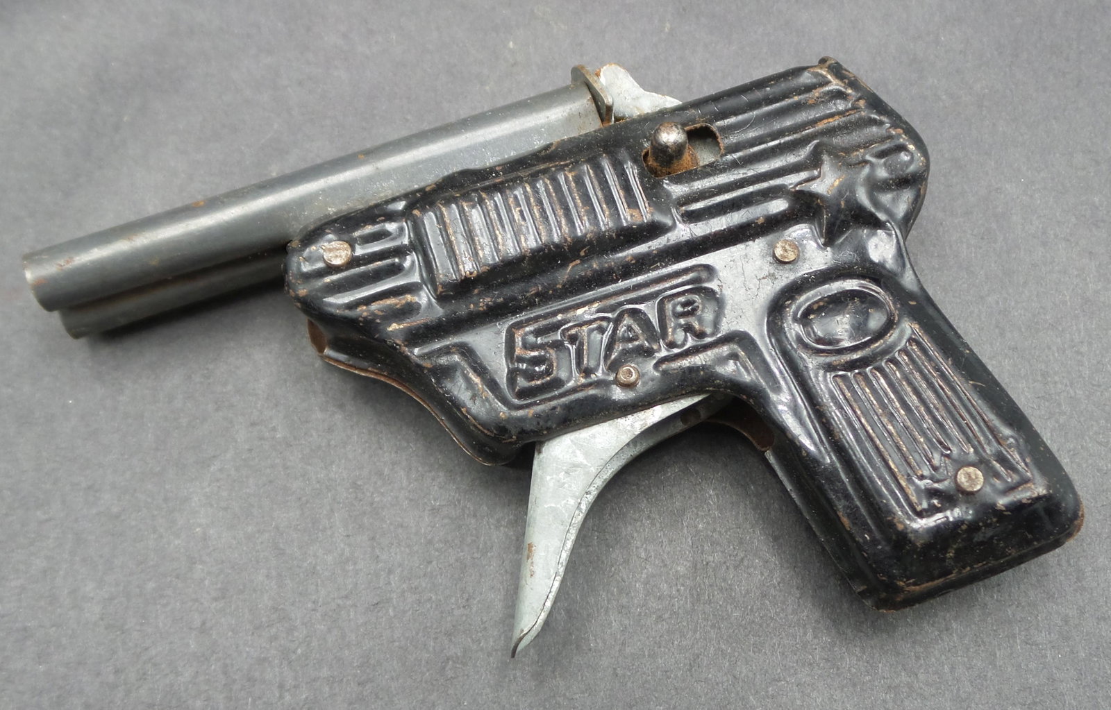 Vintage STAR Tin Cap Gun Toy: Good condition with wear and minor surface corrosion according to age. Measures approx. 3 1/2" long. Works.
