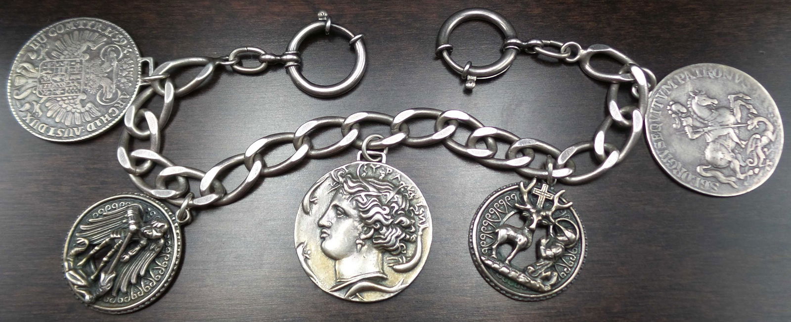 Vintage Mid-Century European 835 Silver & Silver Medal Pocket Watch Chain: This stunning pocket watch chain was handmade around the 1950s, likely in Germany or Austria. It features a thick Cuban link silver chain with silver coins and medals attached to it. The chain is very