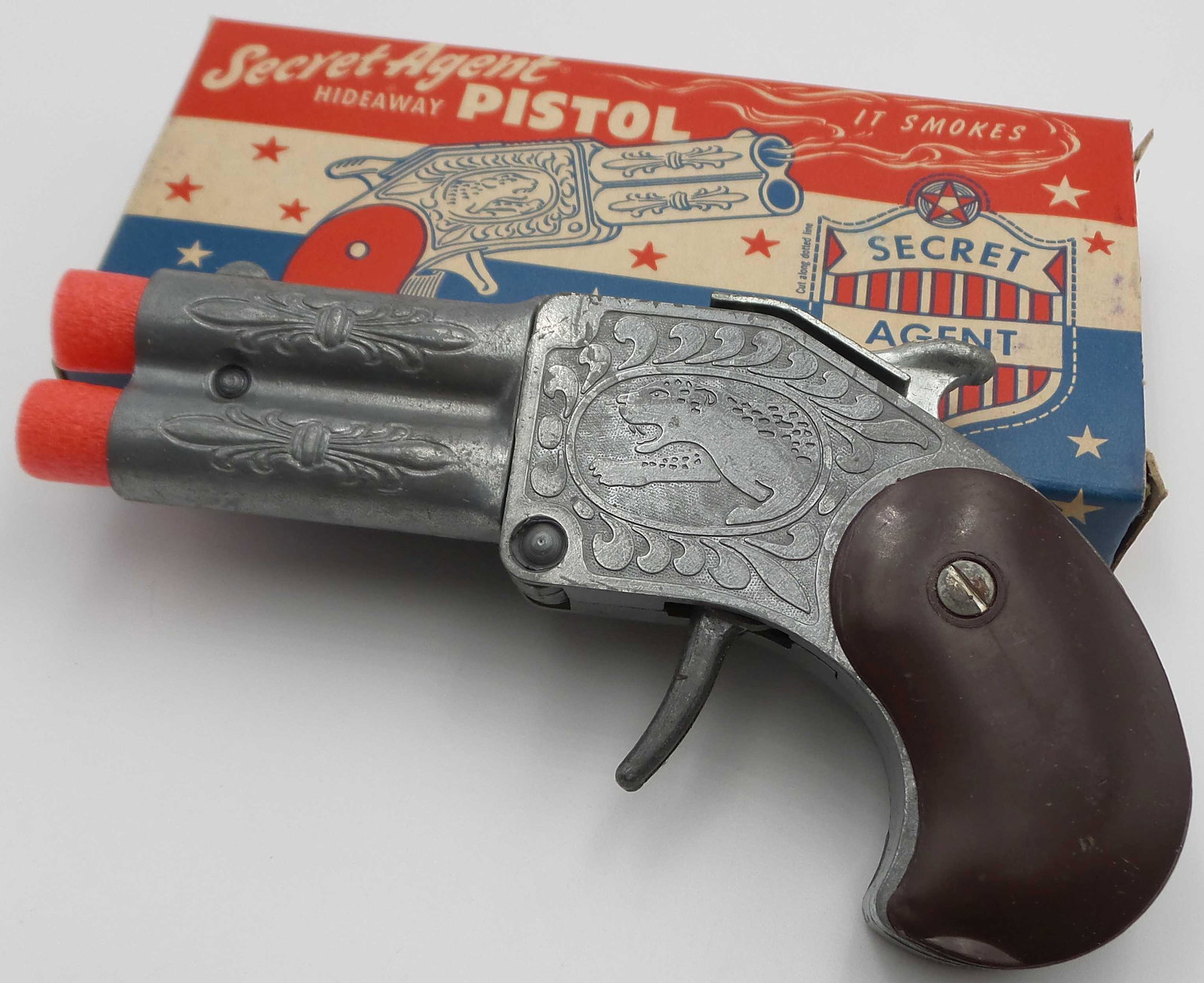 Vintage HAMILTON Secret Agent Hideaway Pistol Toy Cap Gun: Measures approx. 5 1/4" long. New old stock in excellent condition in original box.