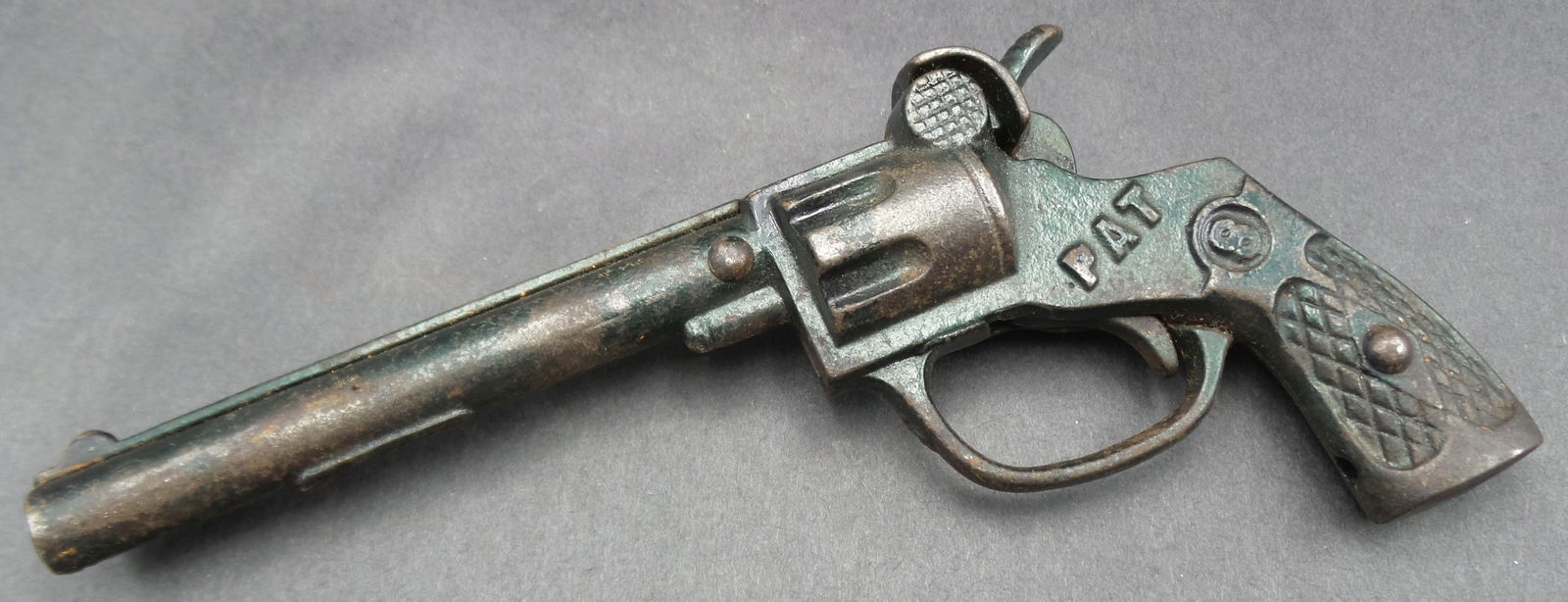 Antique Cast Iron Cap Gun Toy marked "PAT": Good condition with minor wear according to age. Measures approx. 6" long. Works.