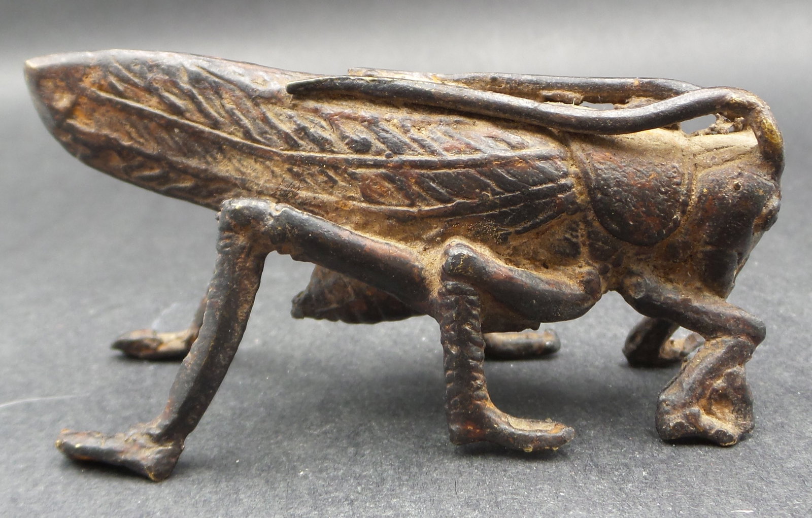 Antique Asian Cast Iron Grass Hopper Figurine: Measures approx. 2 1/2" long x 1 1/2" wide x 1/2" high.