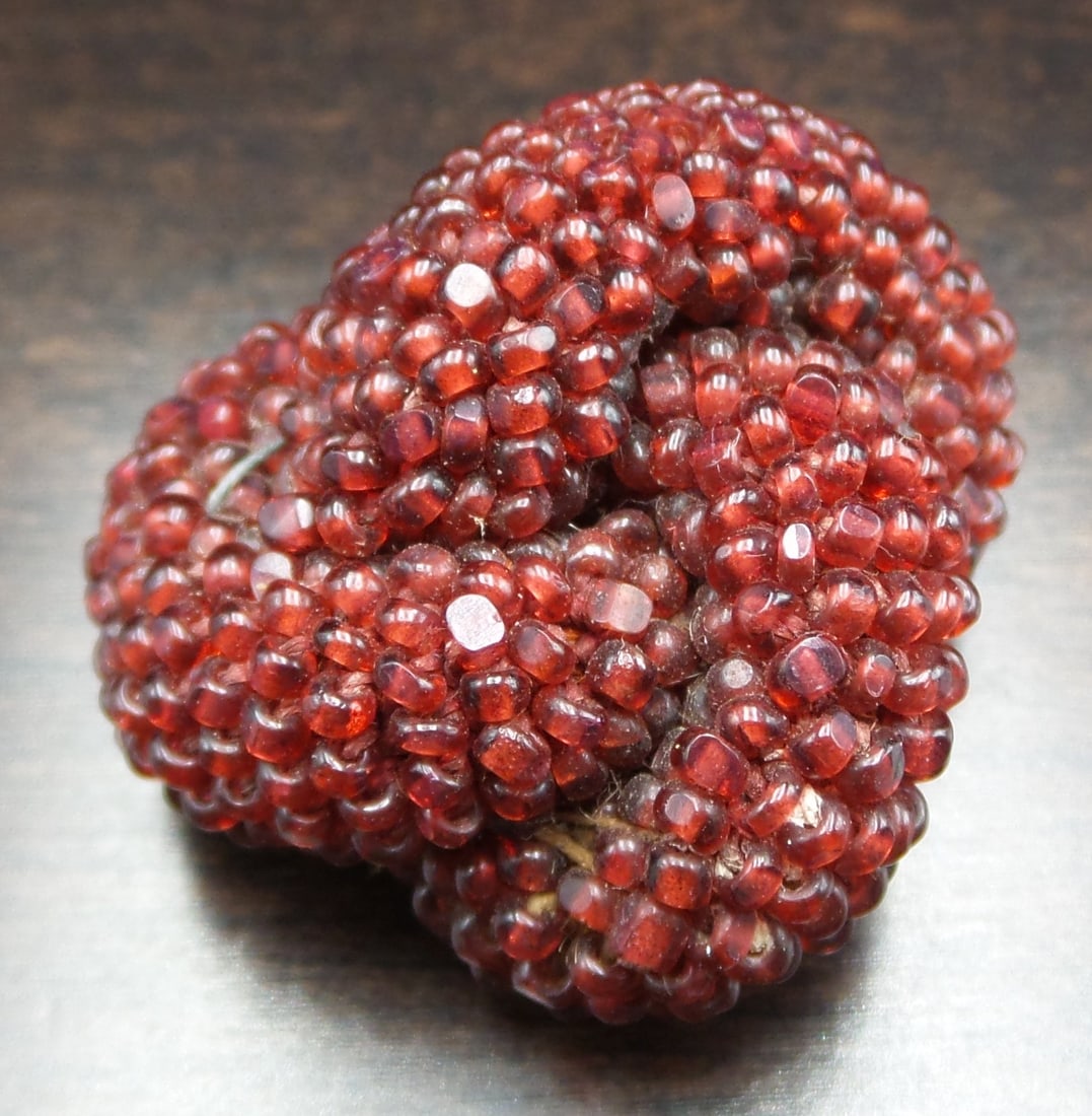 Antique ca. 1910 European Costume Jewelry Red Garnet Bead Knot Brooch: This stunning piece was made around the 1910s in Europe showcasing an amazing level of craftmanship. It features tiny deep red garnet beads aligned on multiple strands worked into a knot shape attache