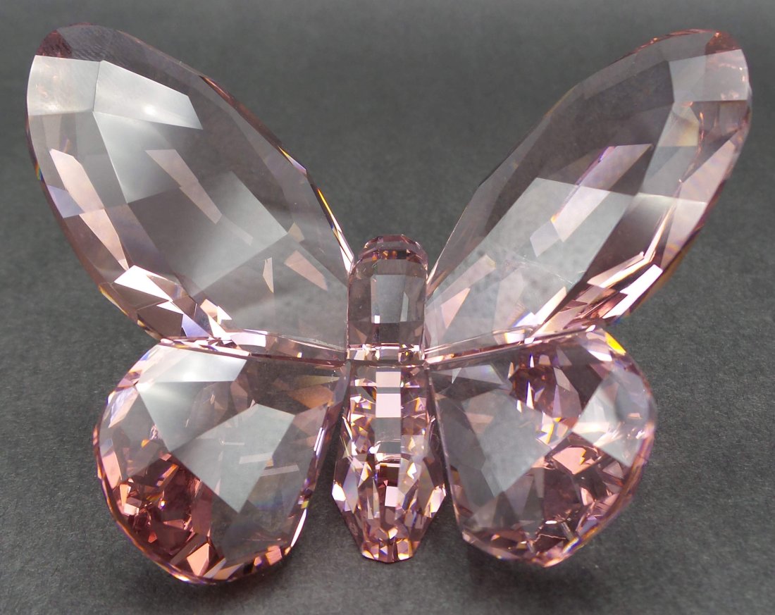 Vintage Discontinued SWAROVSKI Crystal Violet Butterfly Figurine: Butterfly in violet crystal; the first fully colored piece for silver crystal by Swarovski. This gem of nature is a symbol of joy, change, light-heartedness and transformation. Enjoy the magic of this