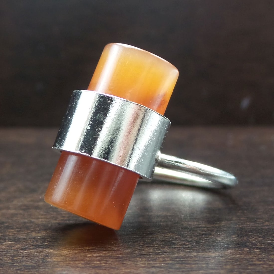 Very Unusual Vintage Mid-Century Modern Stainless Steel & Carnelian Studio Ring: This very unusual mid-century piece features a beautiful orange-red Carnelian gemstone cylinder held by a stainless steel band. The ring is a size 5 but can easily adjusted in size since the ring band