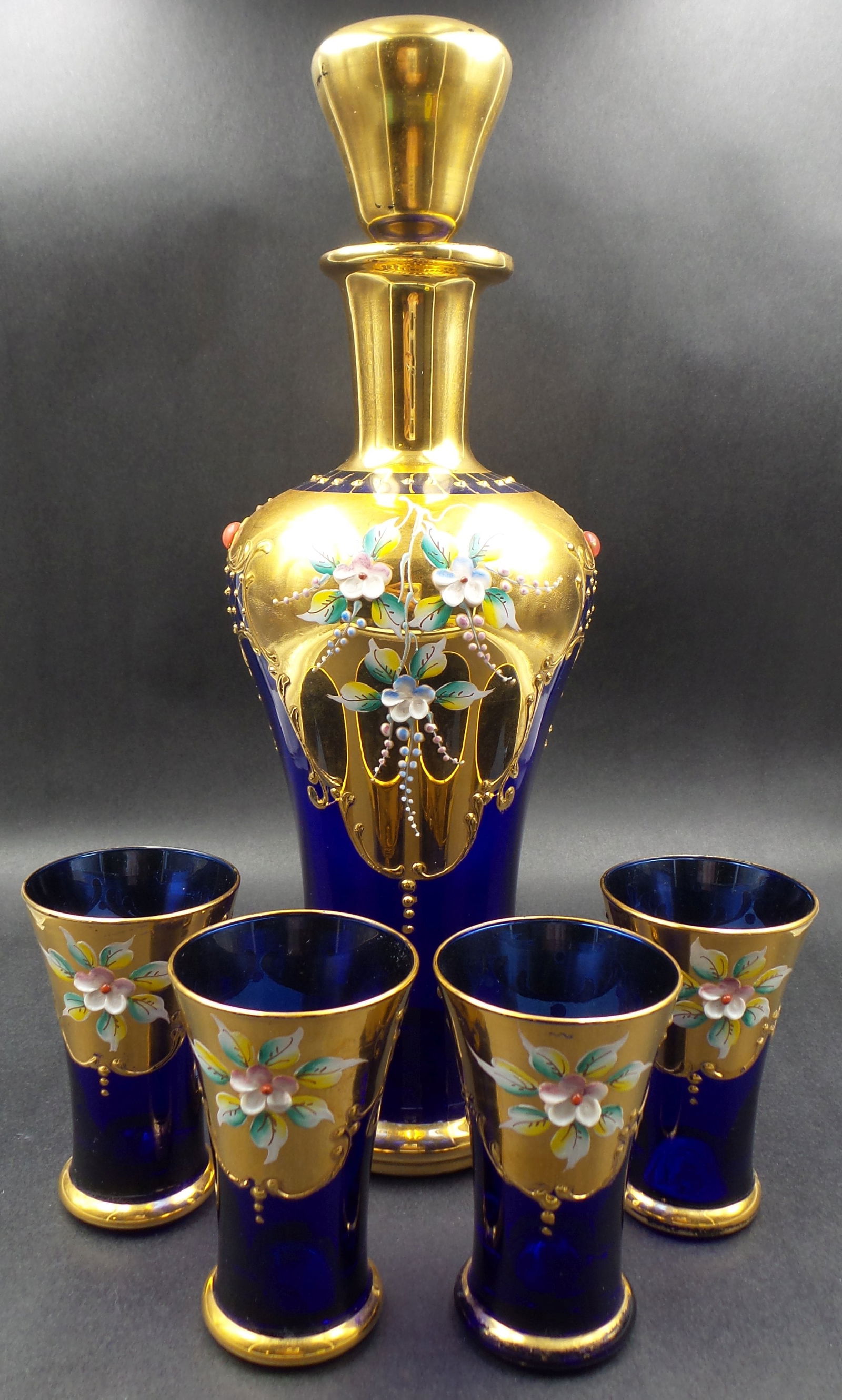 Vintage Venetian Gold & Enamel Painted Cobalt Glass Decanter & 4 Beaker Set: Excellent state of preservation, no chips, cracks, or repairs. The bottle measures approx. 9" tall.