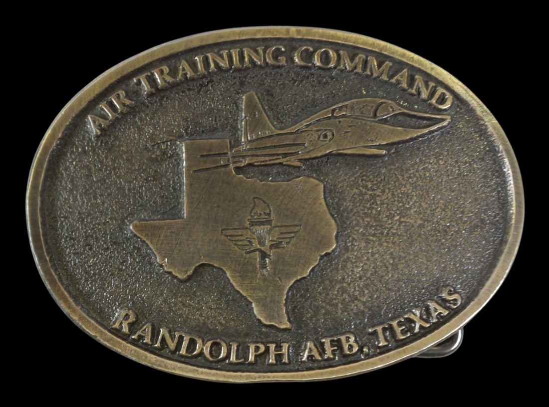 Vintage Air Training Command Brass Belt Buckle - Signed: A vintage brass belt buckle with insription "AIR TRAINING COMMAND RANDOLPH AFB, TEXAS."; signed. Measures approx. 2 1/2" high x 3 1/2" long x 1/4" high.