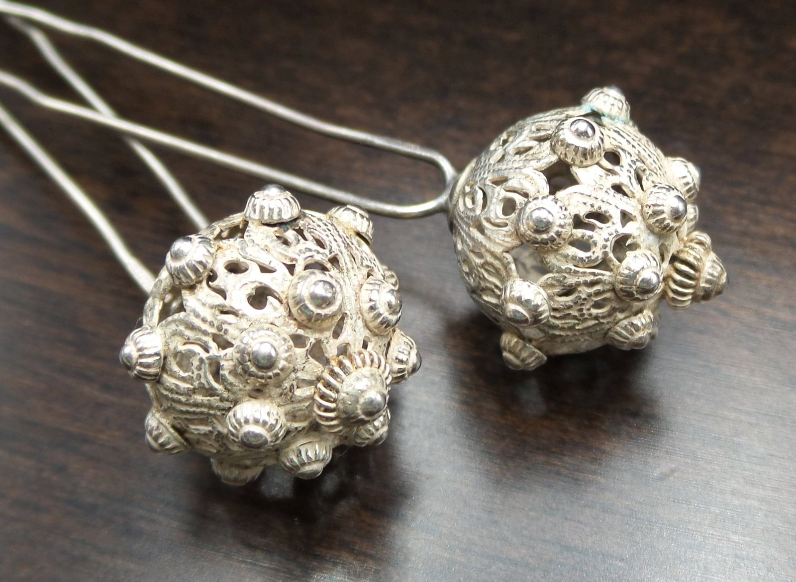 Pair of Antique European Filigree 800 Silver Hair Pins: These beautiful pieces were made around the 1870s in Europe and feature masterfully hand crafted filigree silver balls attached to two long pins. Each measures approx. 4" long and joint weight is ca. 