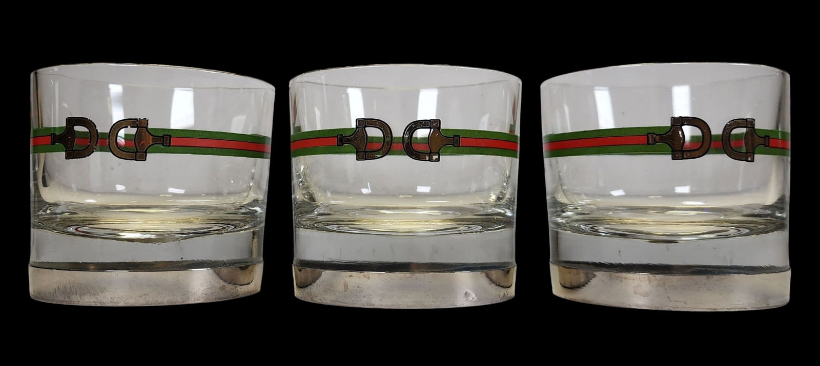 Set of 3 Vintage Mid-Century GUCCI Whiskey Glasses / Tumblers: A rare set of 3 lowball whisky glasses, each mounted with silvered metal and stamped 'Gucci Italy' to the base. Good vintage condition with some wear according to age. No chips, cracks, or repairs. Ea