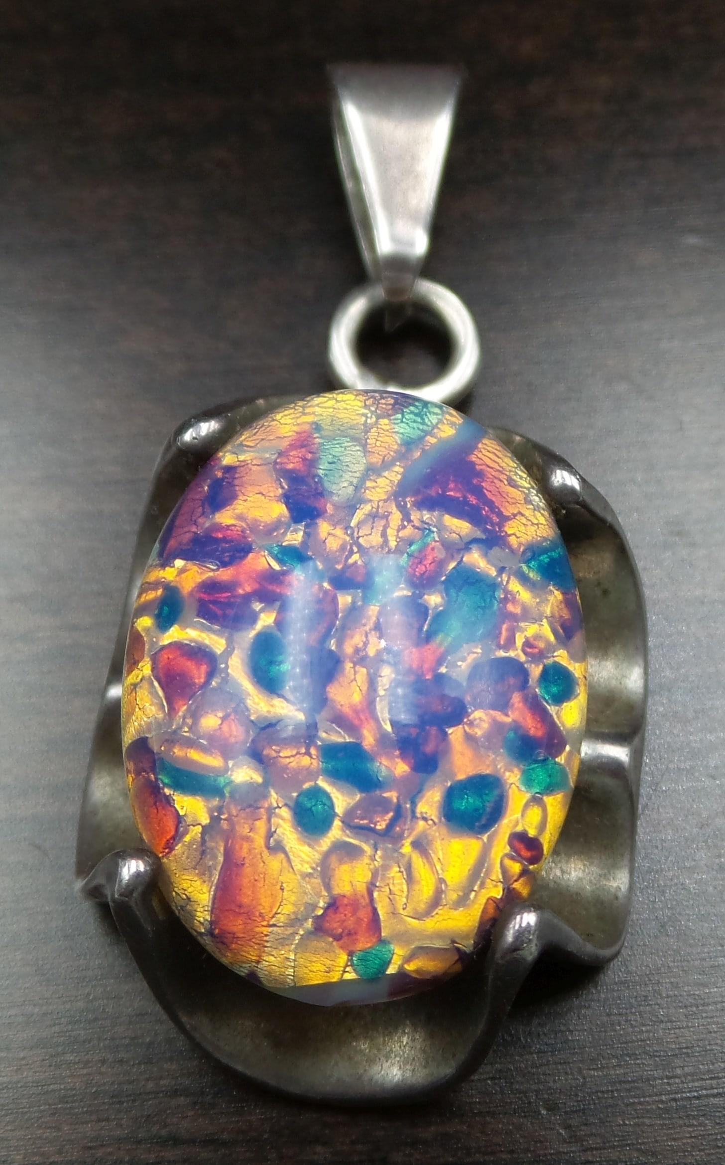 Very Unusual Vintage Sterling Silver & Colorful Glass Stone Pendant: Very unusual eye-catcher in very good vintage condition with some patina according to age; no damage to the stone. Measures approx. 1 1/2" long x 3/4" wide. Marked on the back.