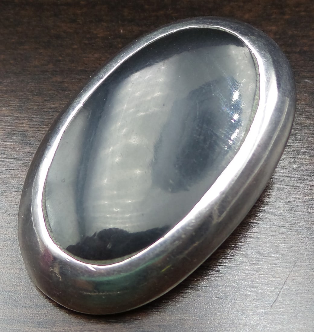 Large Vintage Mid-Century Mexican Sterling Silver & Black Onyx Pendant / Brooch: Beautiful vintage piece featuring a large Onyx gemstone in a Sterling Silver frame. The piece measures approx. X and weighs ca. Y. Very good vintage condition with some patina according to age. Marked