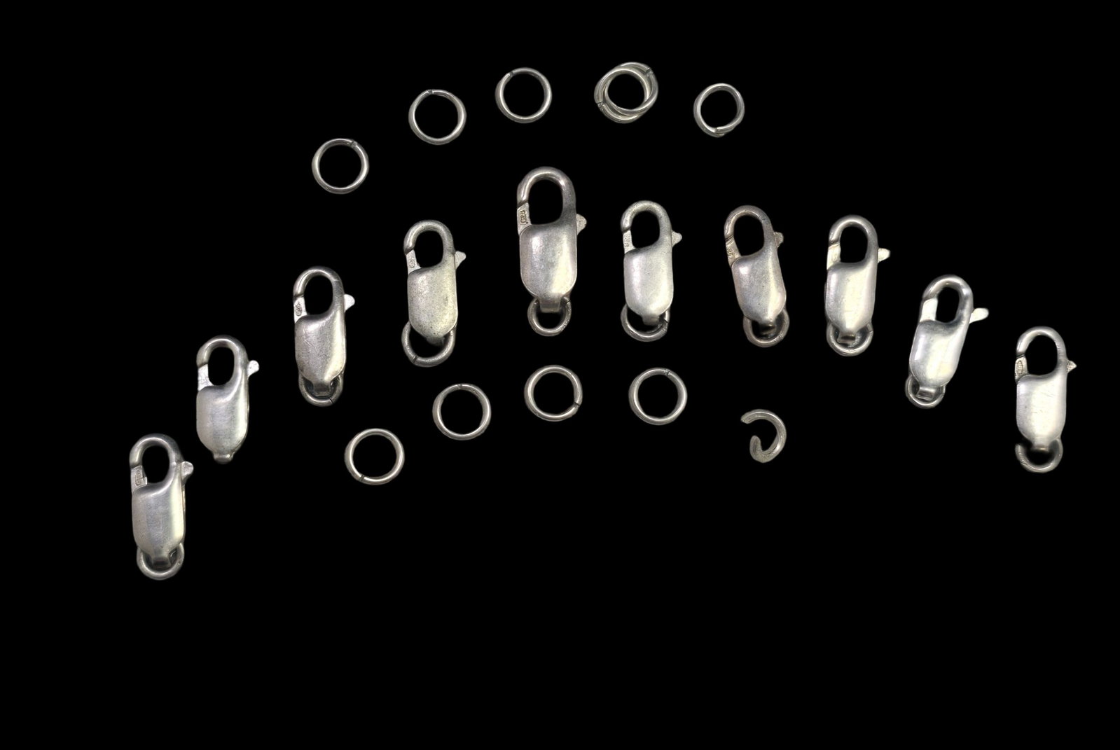 Lot of 10 Sterling Silver Lobster Clasps: Very good vintage condition with minor patina and wear according to age. Each measures approx. 1/2" high and weighs ca. 1 gram. Marked for Sterling Silver. SHIPPING: We ship in-house and charge a flat