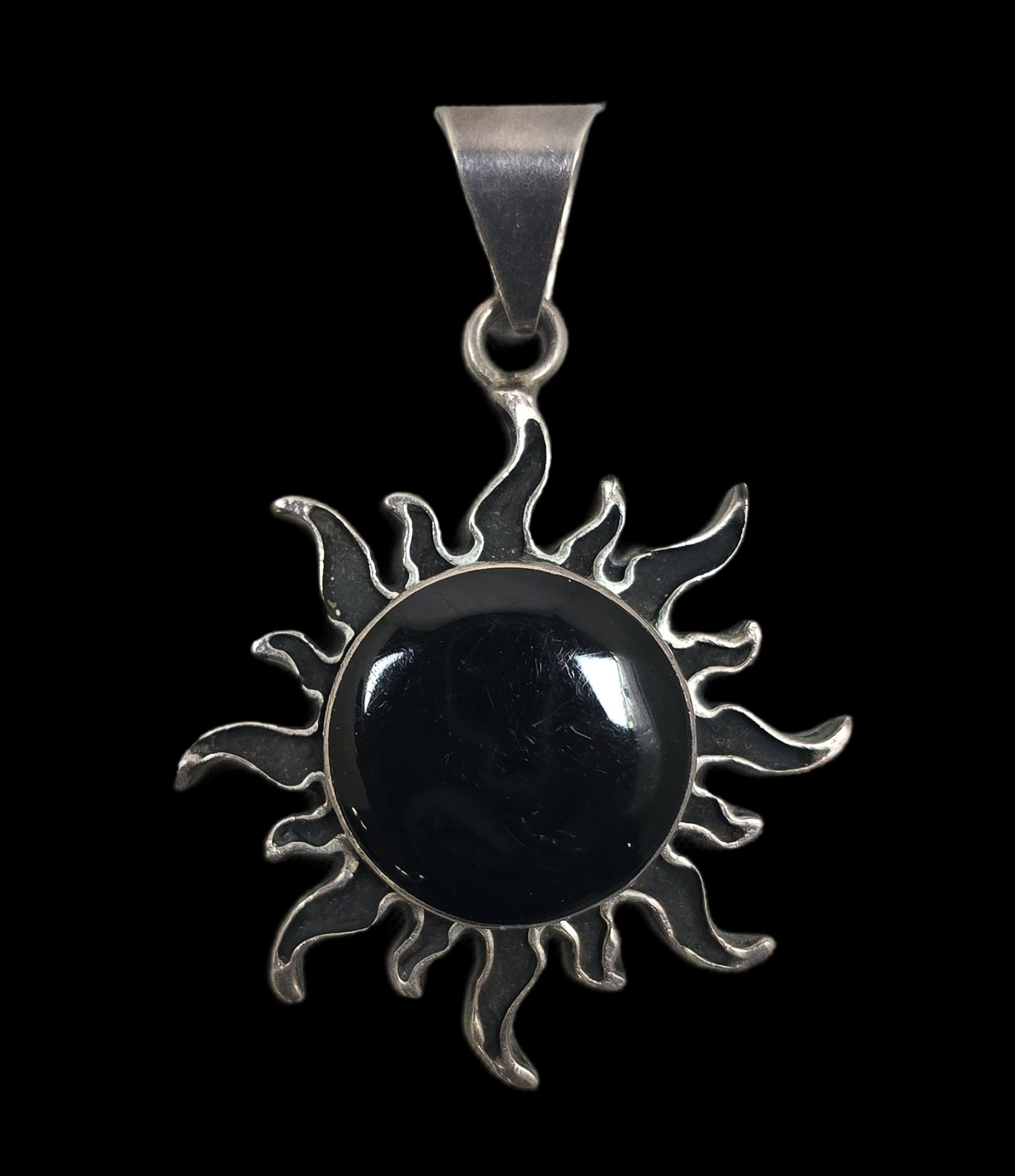 Unusual Vintage Mexican Sterling Silver & Black Onyx Sun Pendant: Very good vintage condition with minor patina and wear according to age. Measures approx. 2" high x 1" wide and weighs ca. 17.5 grams. Marked for Sterling Silver. SHIPPING: We ship in-house and charge
