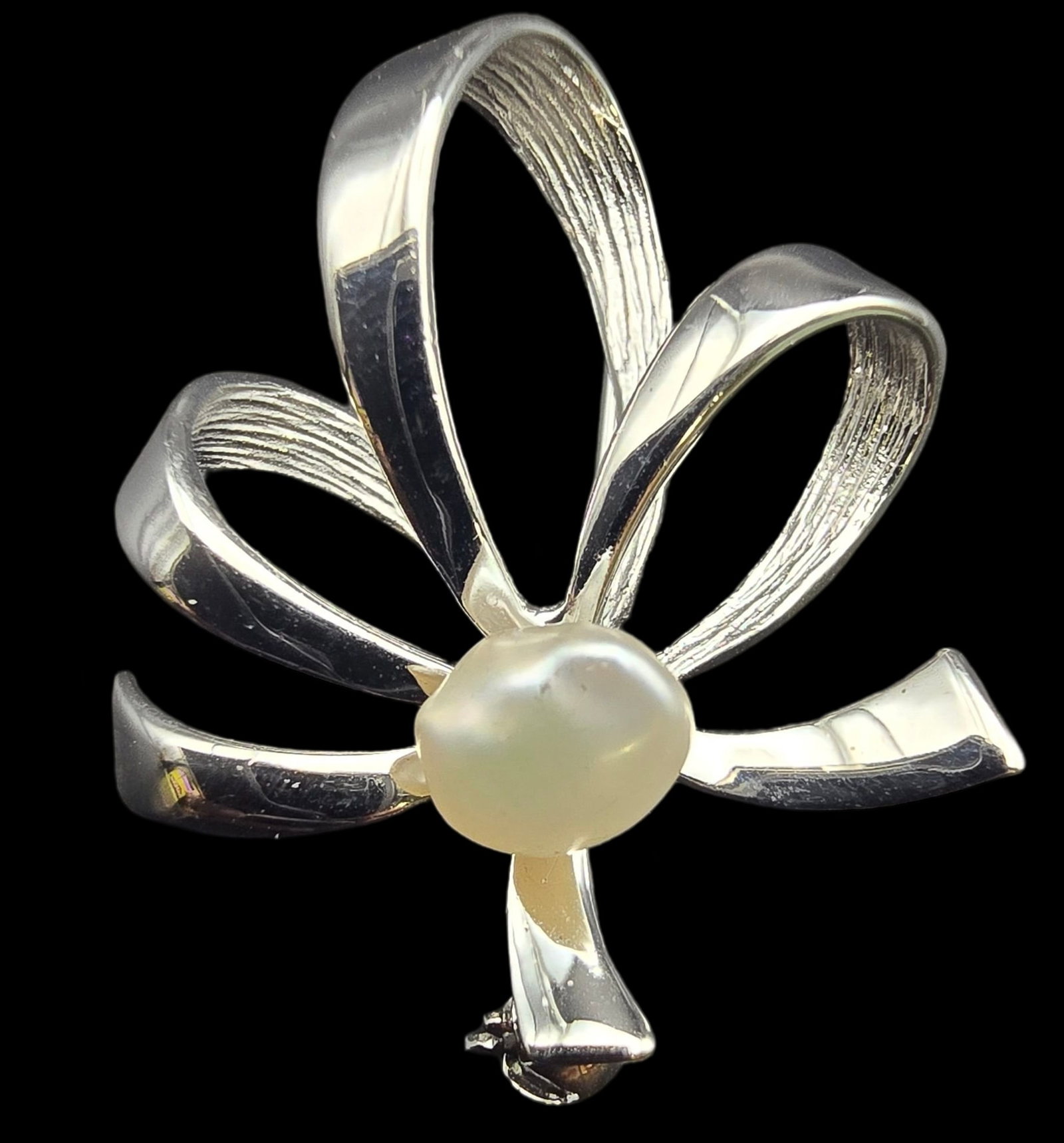 Vintage Mid-Century Sterling Silver & Pearl Bow Shaped Pin: Very good vintage condition with some patina and wear according to age. Measures approx. 1" long, 1" wide and weighs ca. ca. 3.2 grams. Marked for Sterling Silver. SHIPPING: We ship in-house and charg